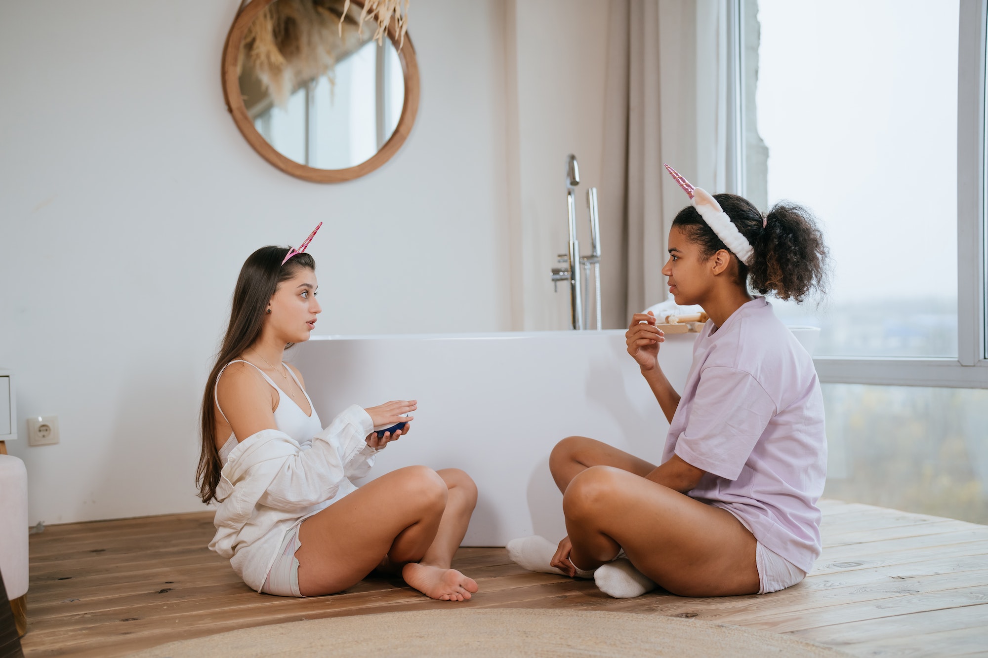 two-girls-talking-on-the-bathroom-floor